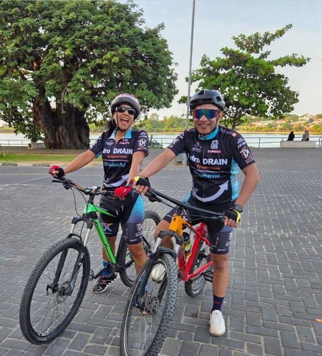A couple posing with their mountain bikes