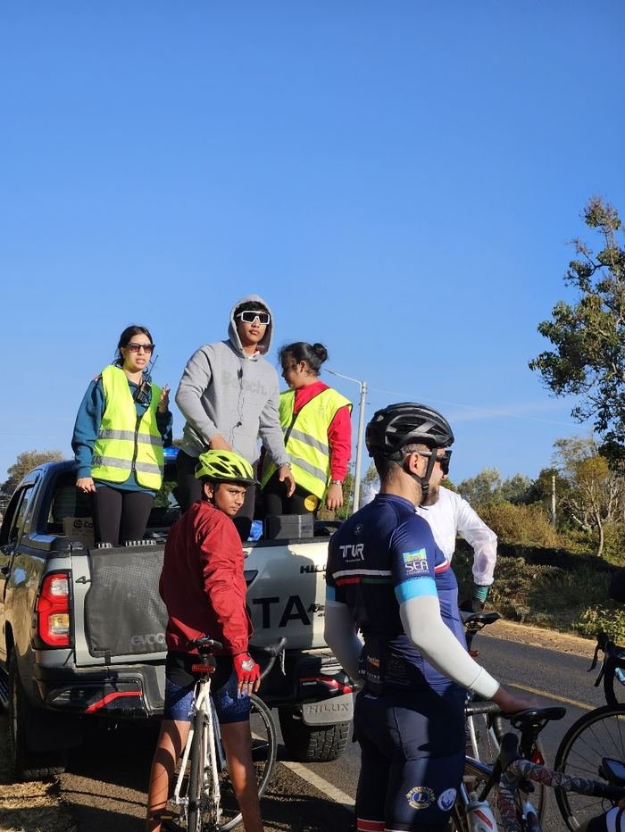 Ride marshals in high-visibility vests coordinating from a support vehicle