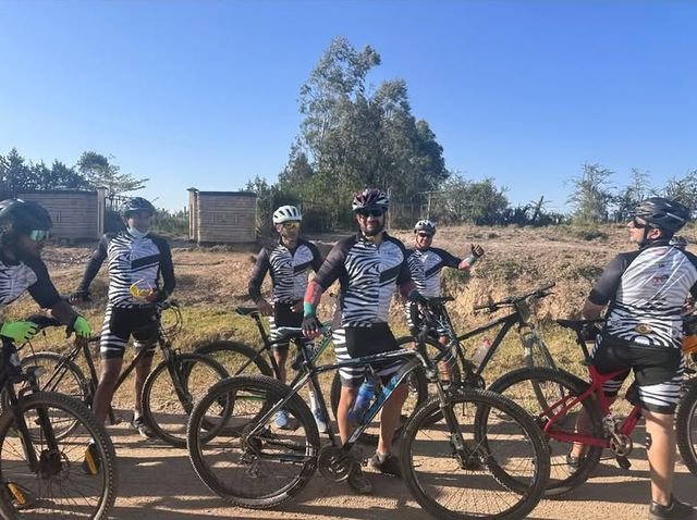 A group of off-road riders stopped at a watering hole